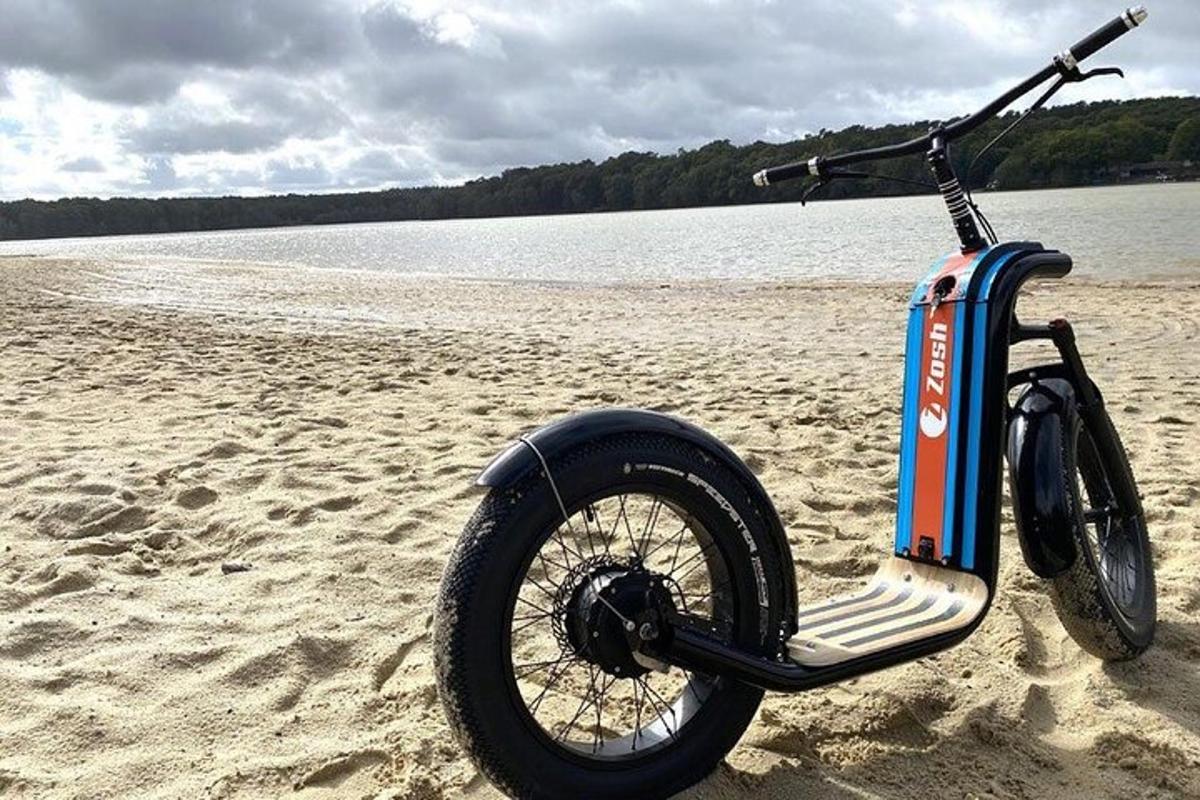 a motor scooter parked on a beach near the water