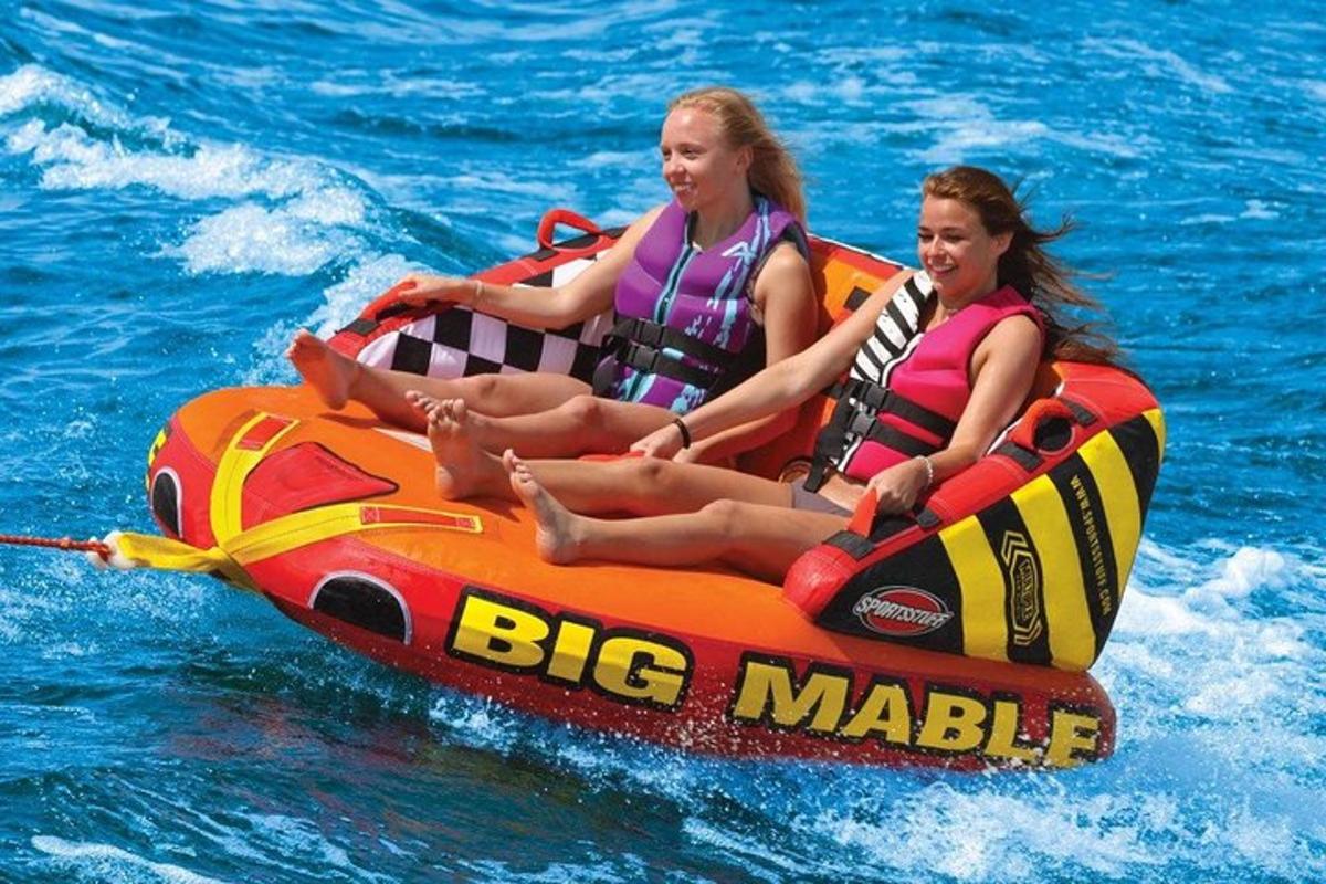 due ragazze stanno viaggiando su una zattera arancione nell'acqua