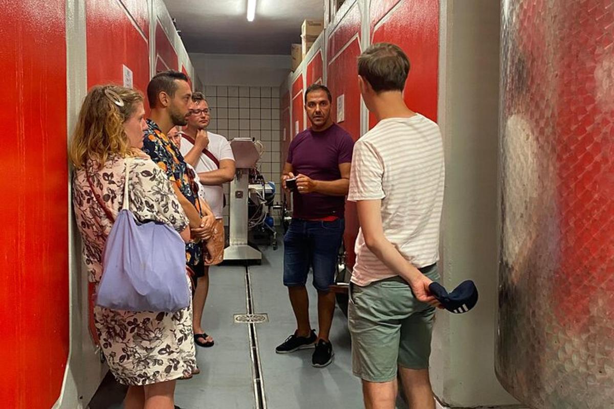 a group of people standing in a bathroom stall