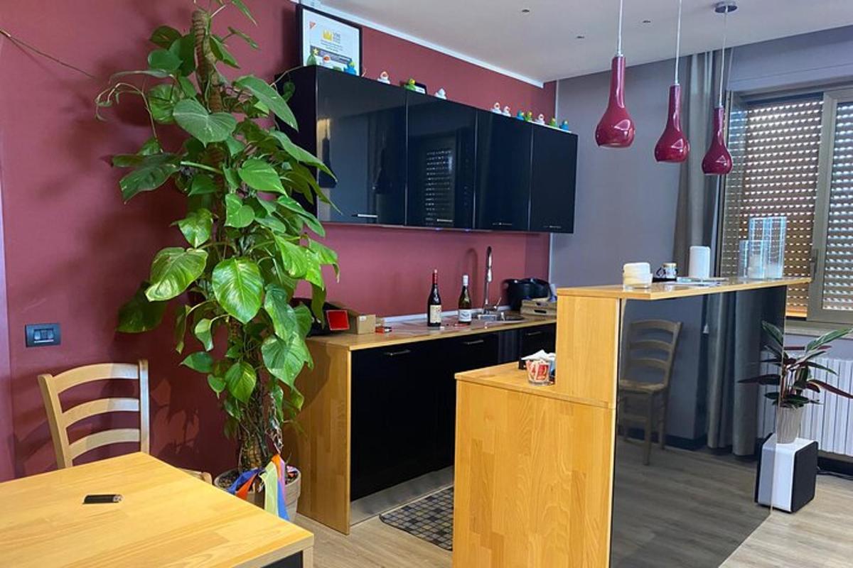 a kitchen with a table and a plant