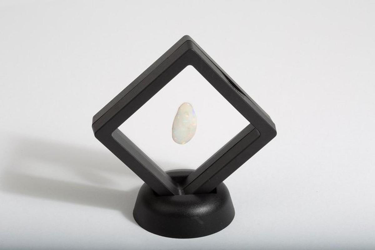 a black candle holder with a stone in it