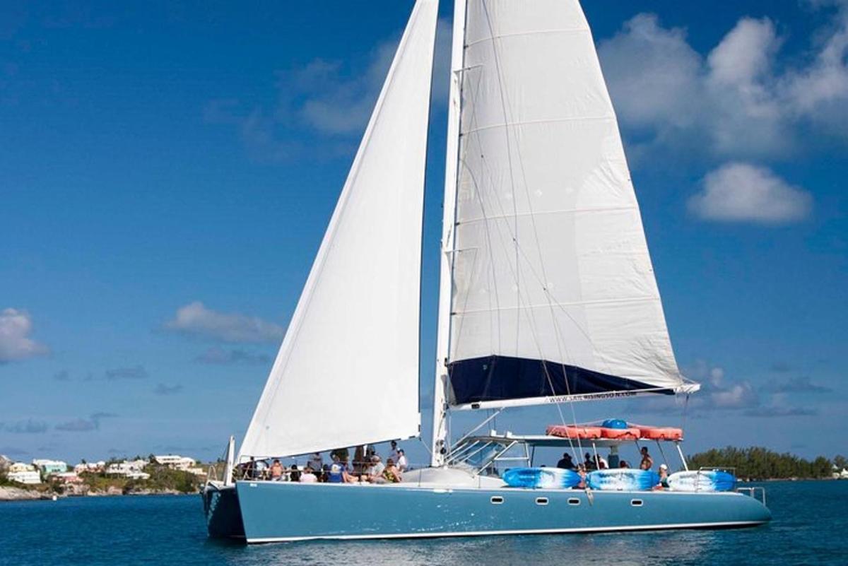 a sailboat with people on it in the water