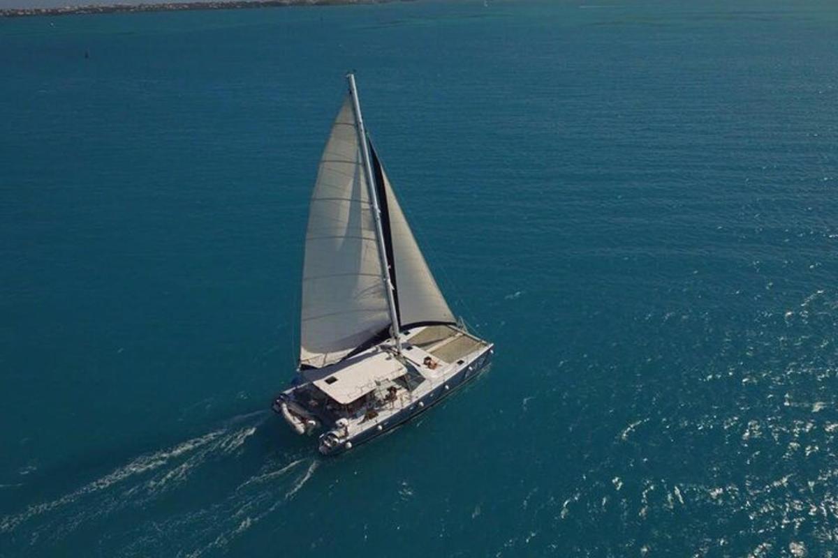 a boat with a sail in the water
