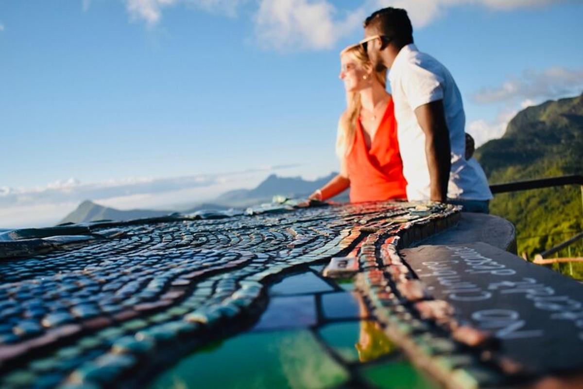 a man and a woman standing on top of a mountain