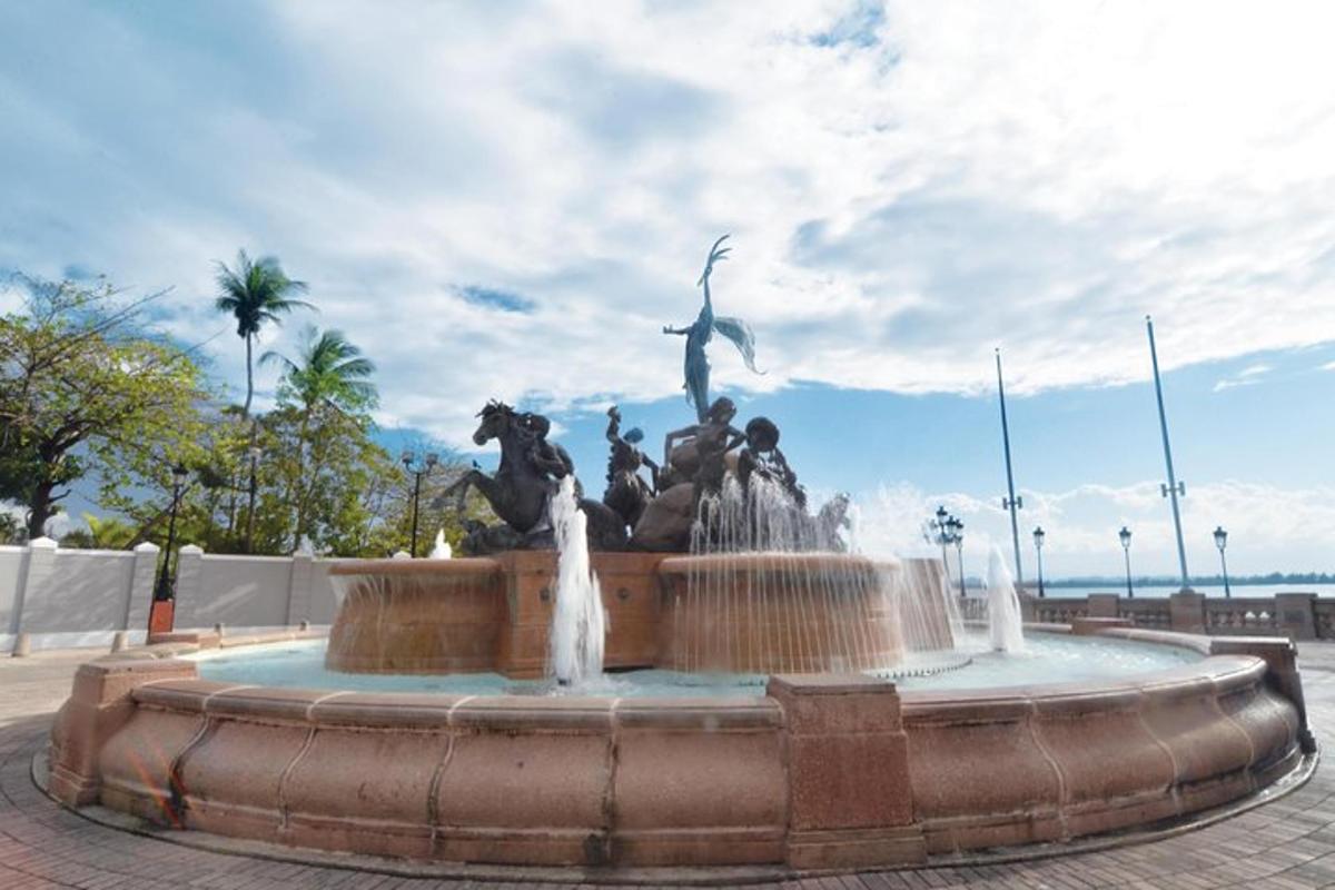 a fountain with a statue in a park
