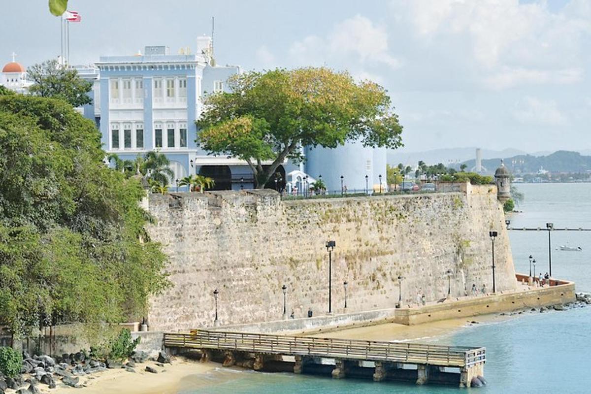 a stone wall with a pier next to the water