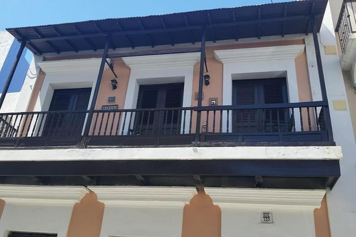 a balcony of a building with black shuttered windows