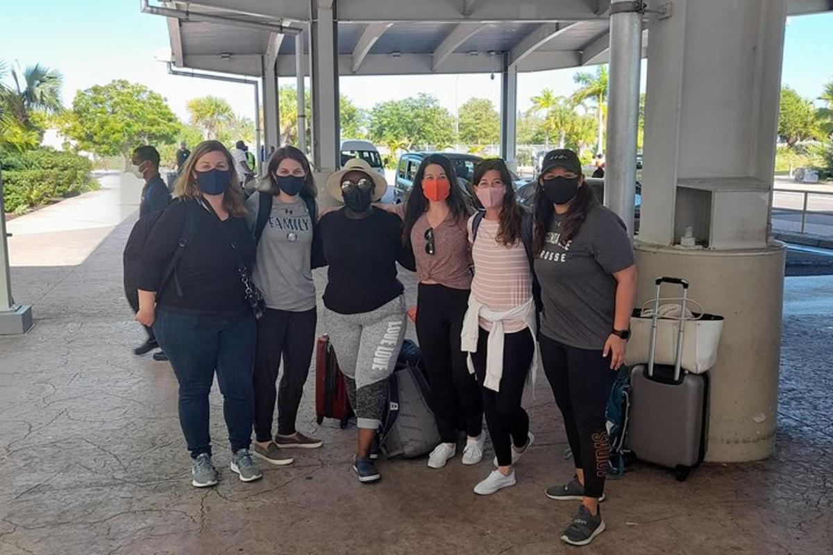 a group of people wearing masks posing for a picture