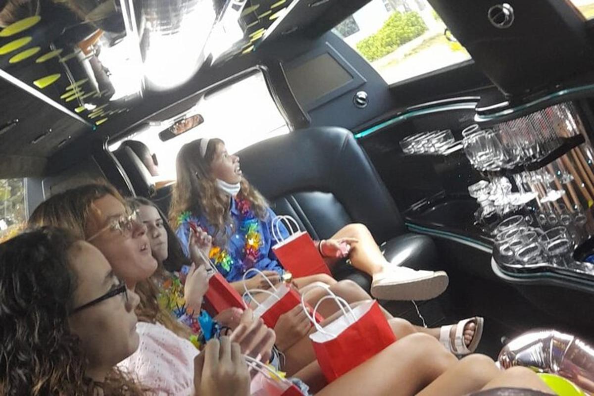 a group of people sitting in a limo with drinks