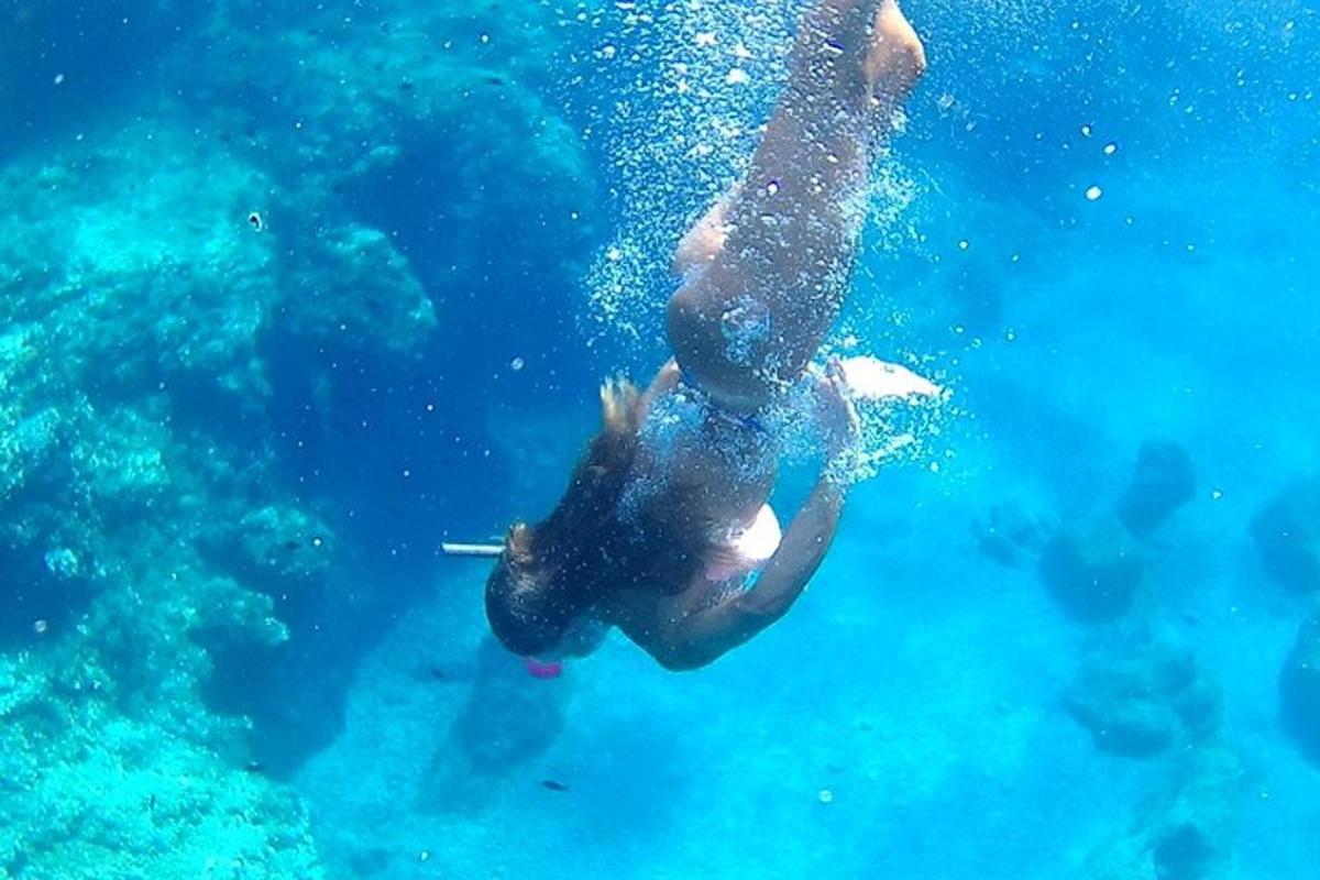 a person is swimming in the blue water