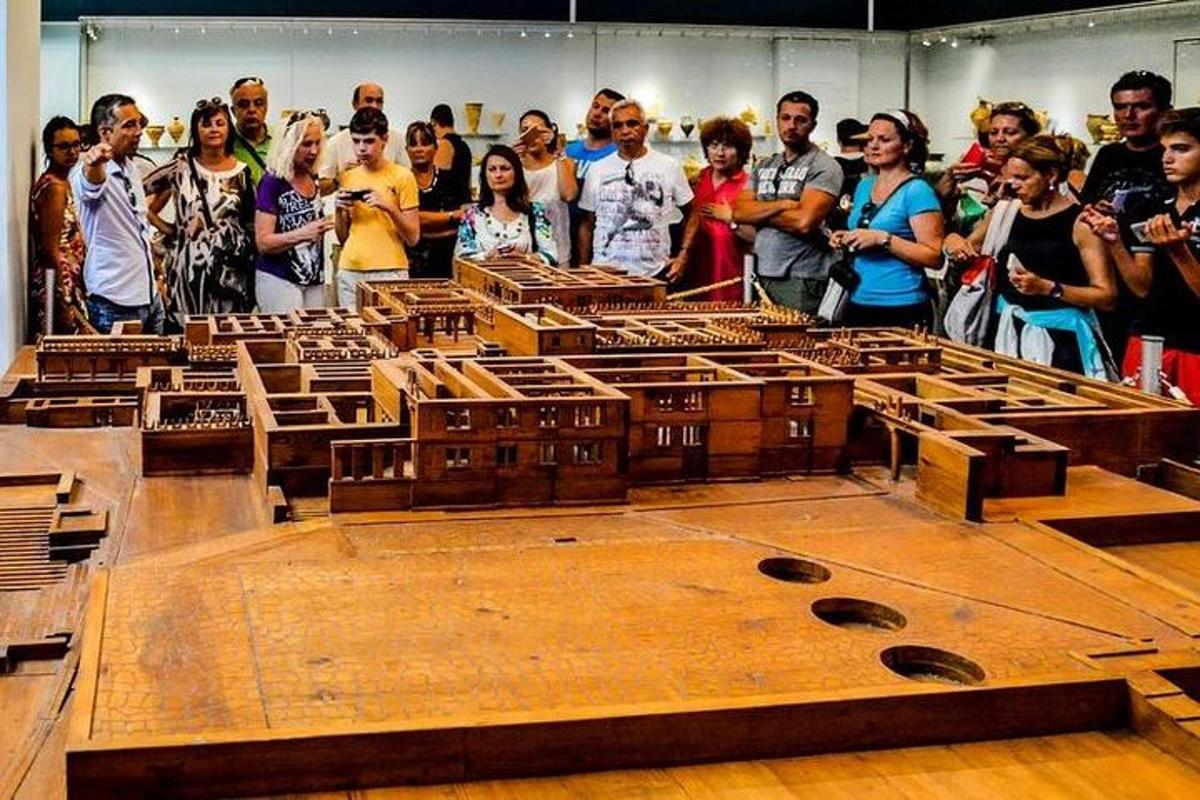 a group of people standing around a large wooden table