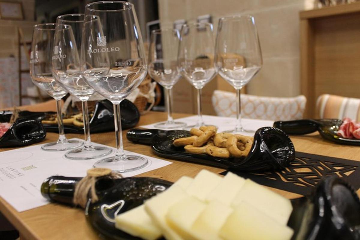 a table with wine glasses and cheese on it