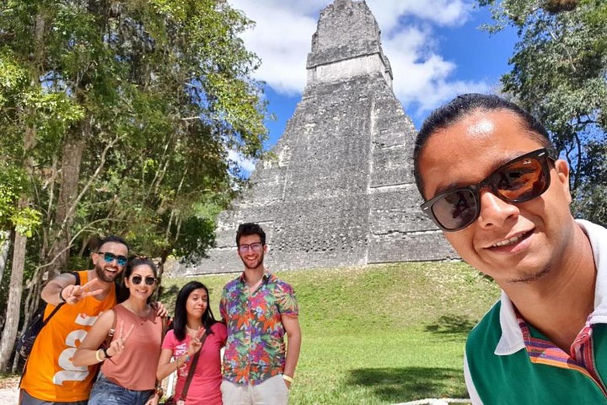a group of people standing in front of a pyramid
