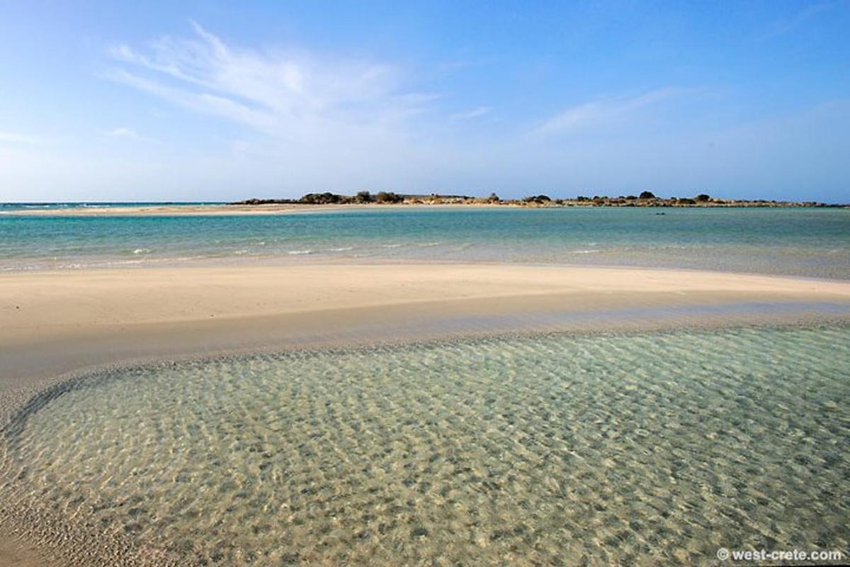 egy tiszta vizű strand és egy sziget a távolban