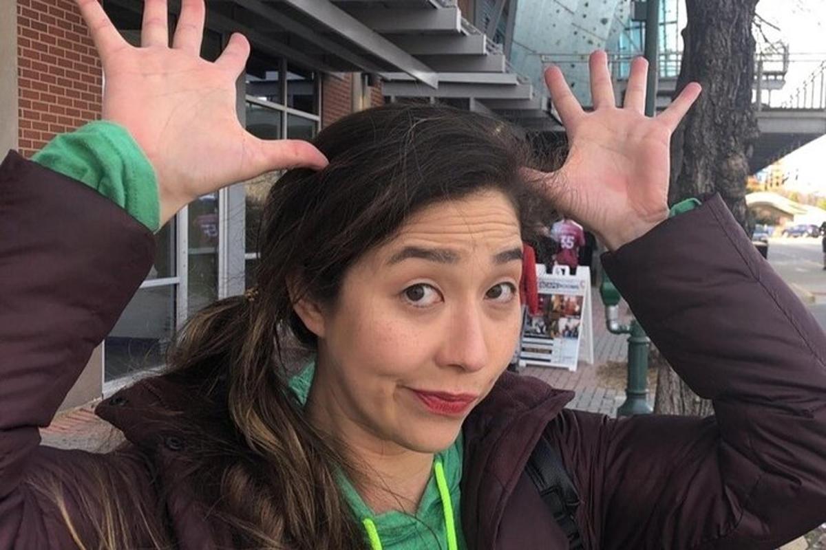 a woman with her hands up in the air