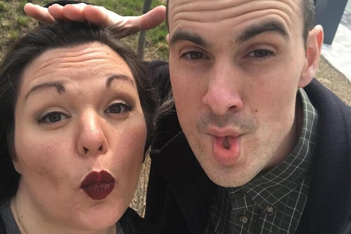 a man and a woman sticking their tongue
