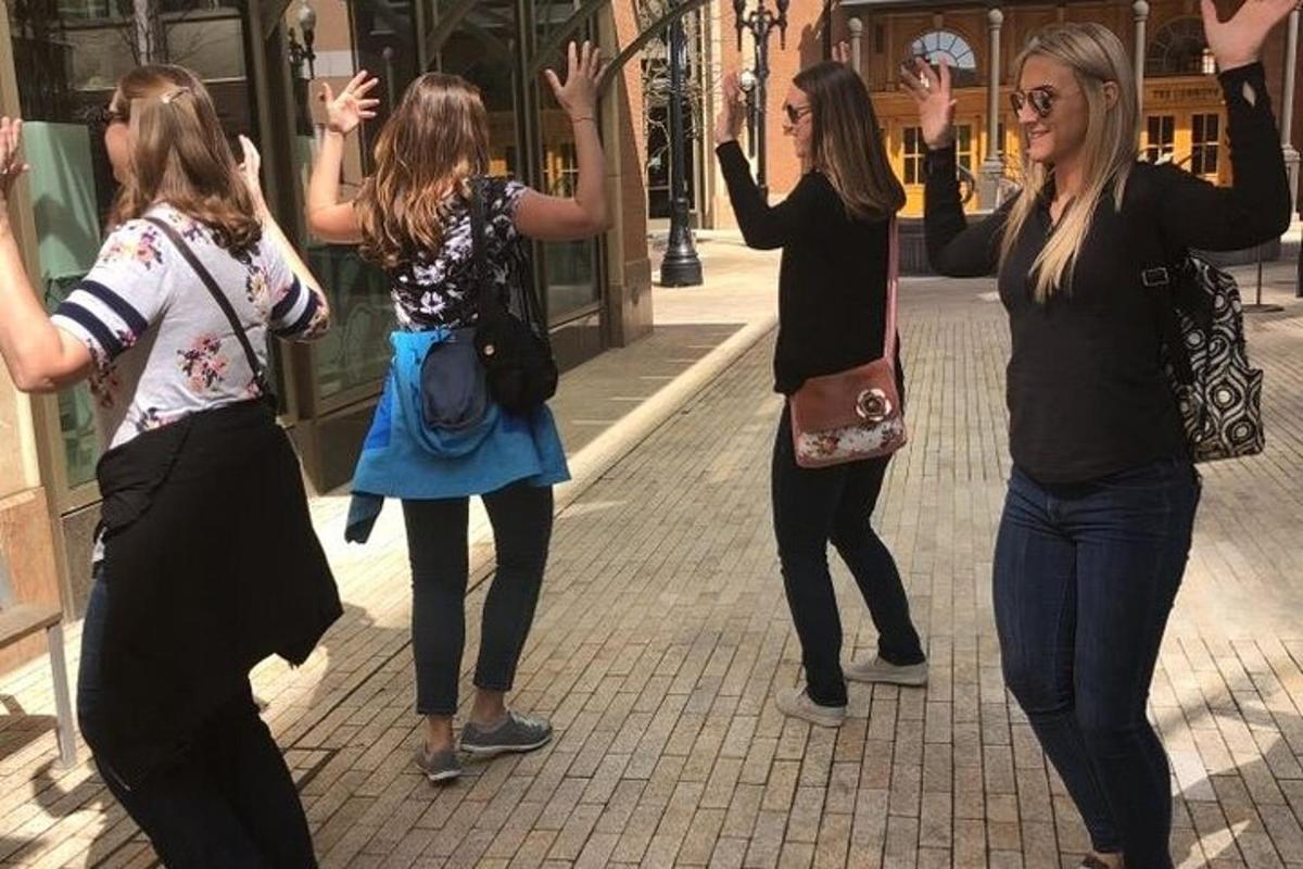 a group of women dancing on a street