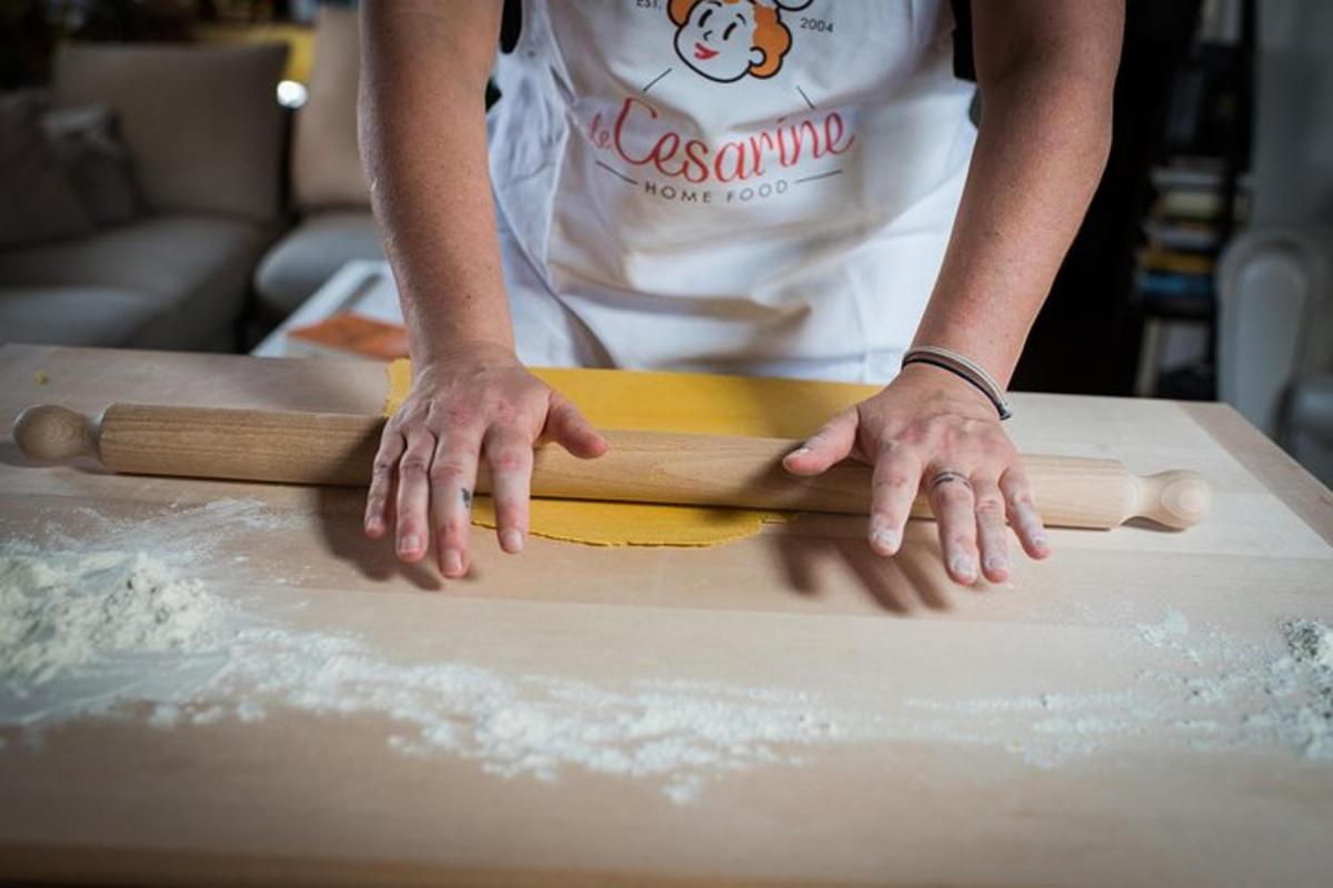 a person cutting a piece of wood on a cutting board