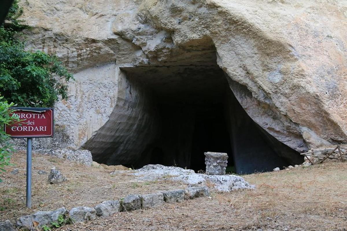 una grande grotta con un cartello davanti