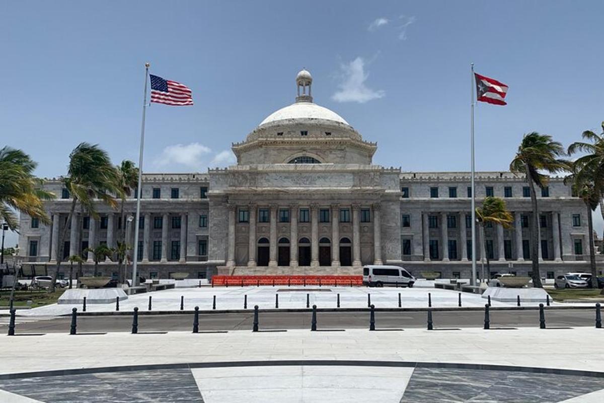 a large building with two flags in front of it