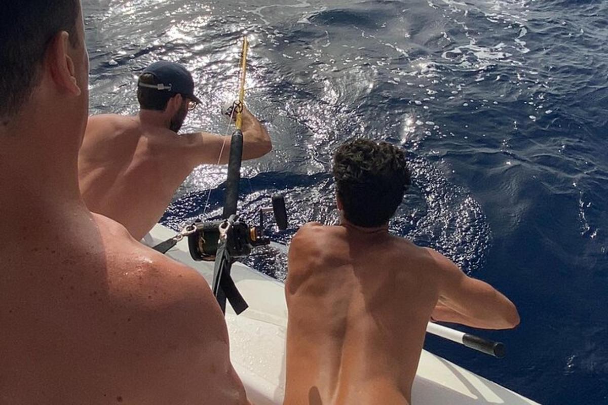 two men sitting on a boat in the water