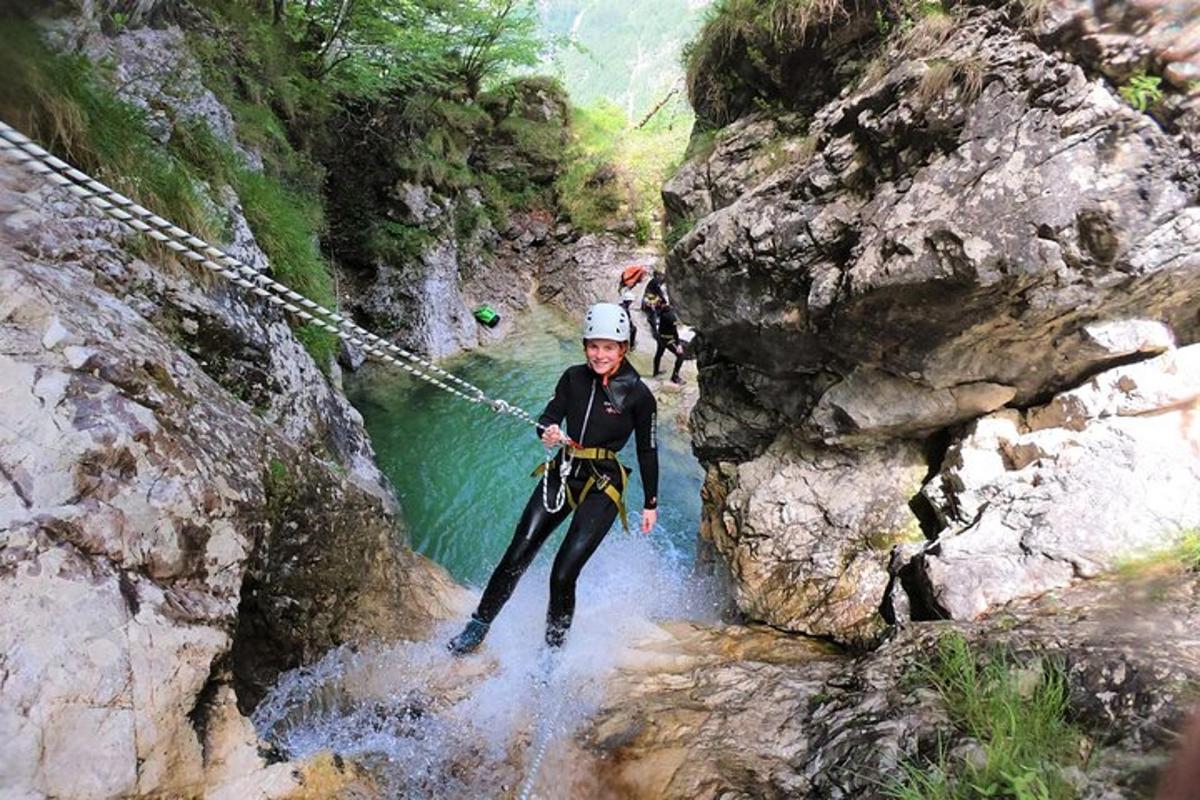 a person on a rope bridge over a river