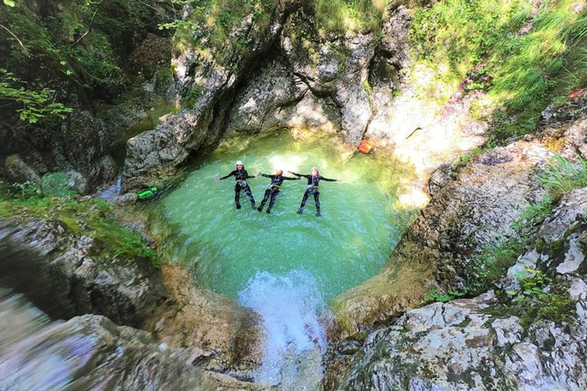 three people are standing in the water in a river