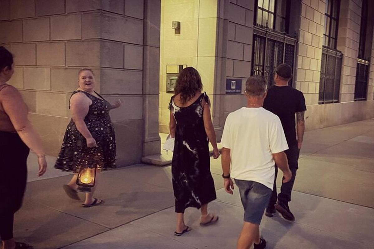 a group of people walking around a building