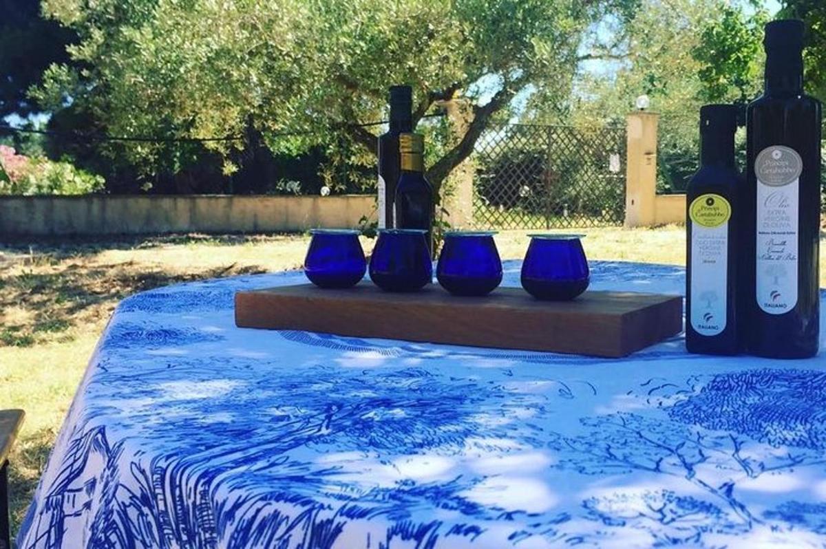 a table with blue vases and bottles of wine