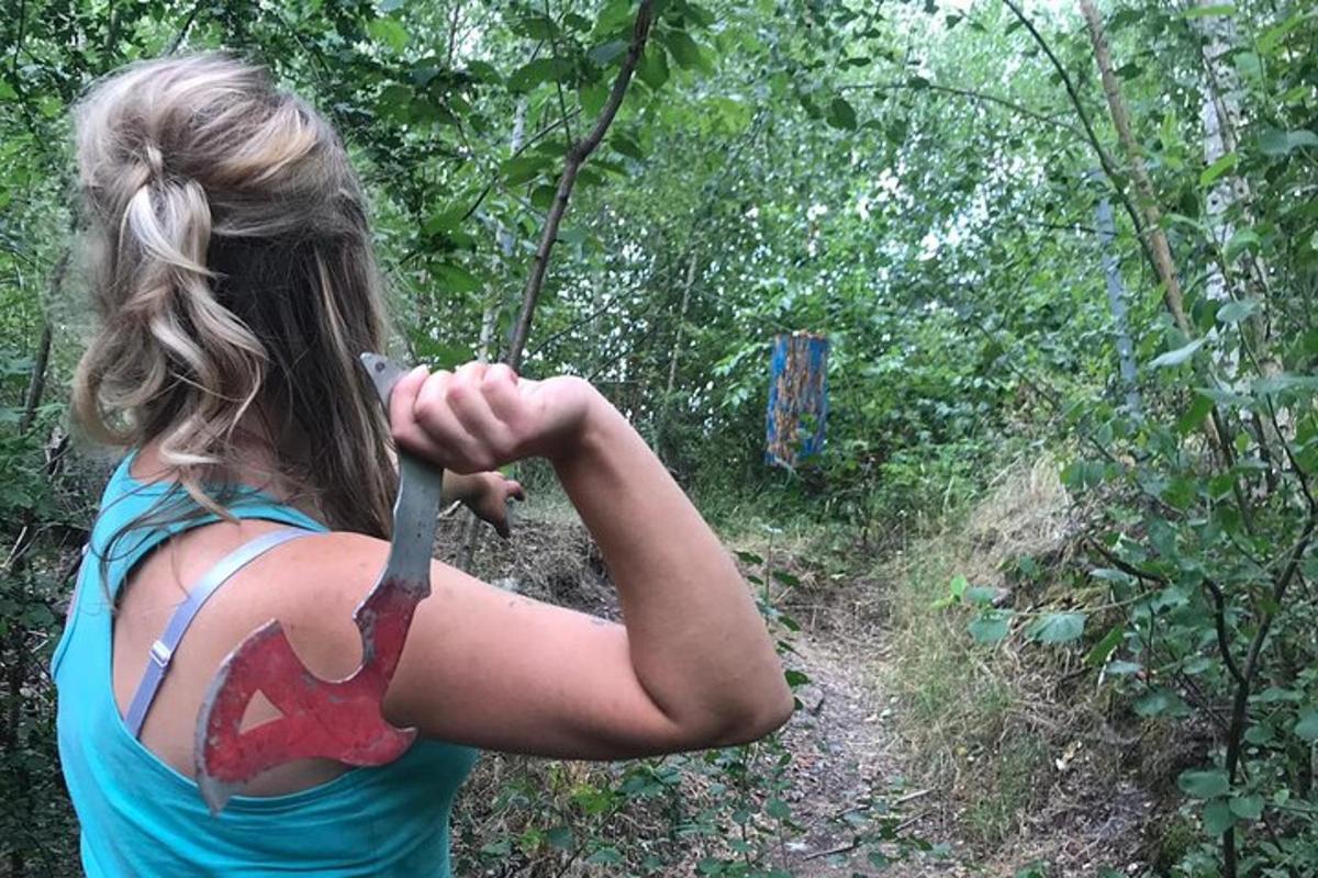 en kvinde, der holder en kniv i skoven