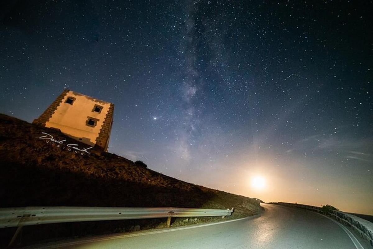 um carro dirigindo por uma estrada sob um céu estrelado