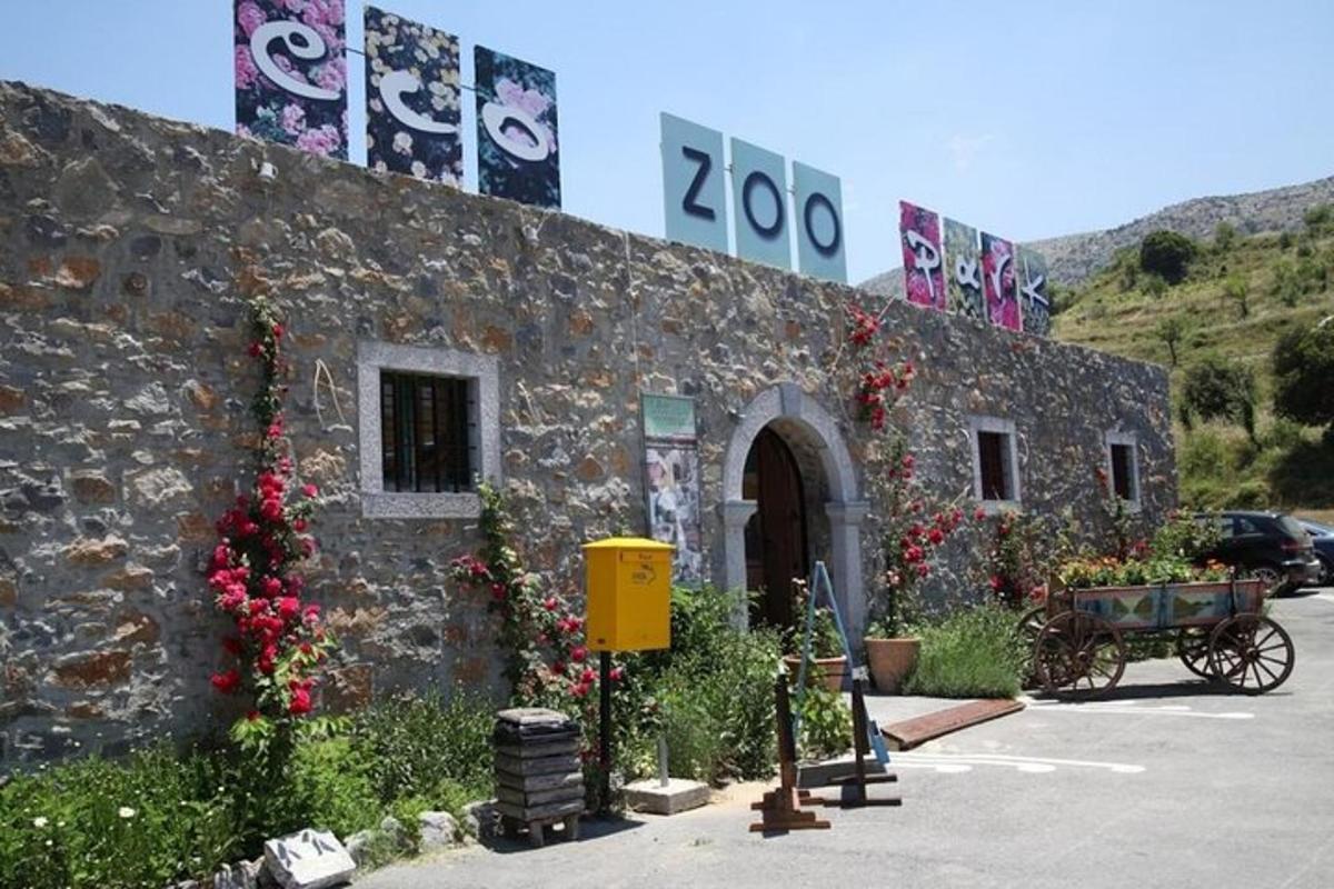 a stone building with flowers on the side of it