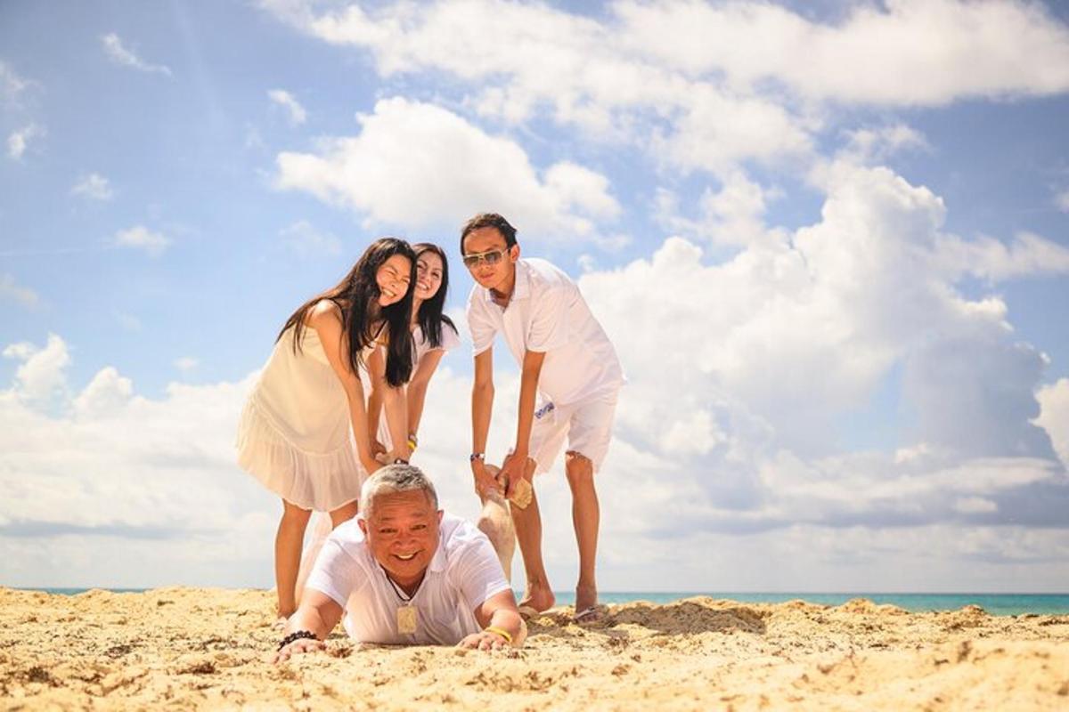 a family playing in the sand on the beach