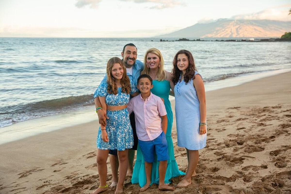 a family poses for a picture on the beach