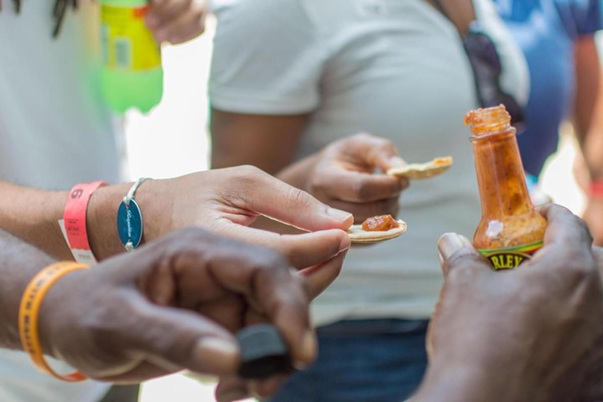 a group of people eating food with a bottle of sauce