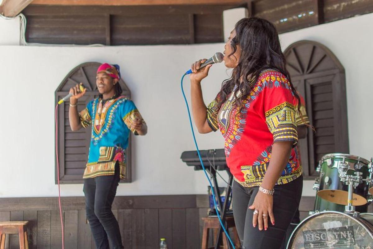 two women singing into a microphone on a stage