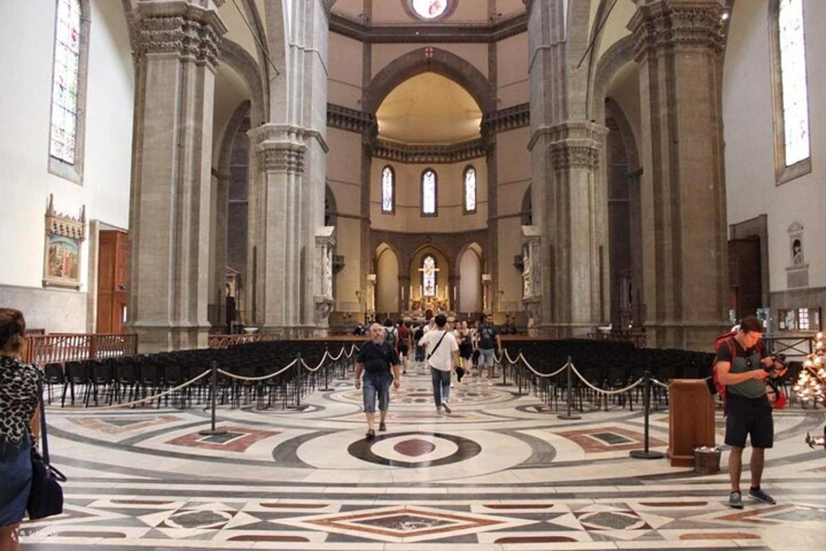 a group of people walking in a large cathedral