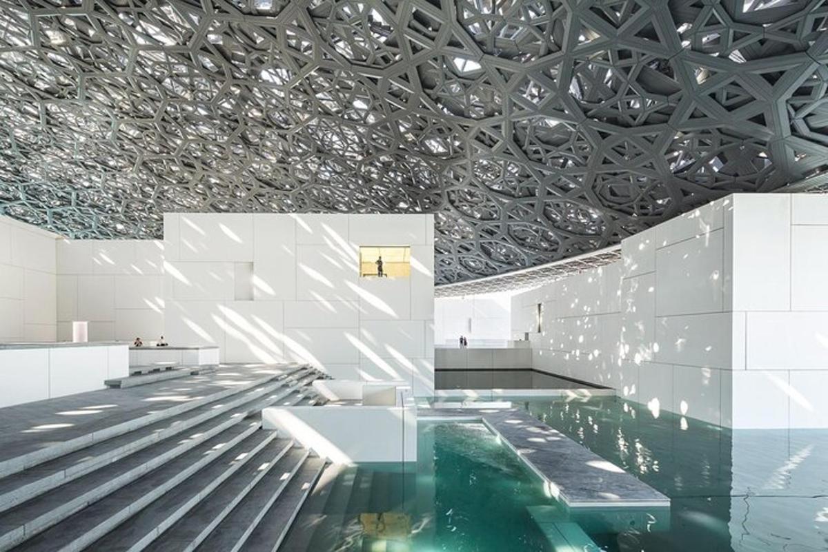 a lobby with a pool and a ceiling with mirrors