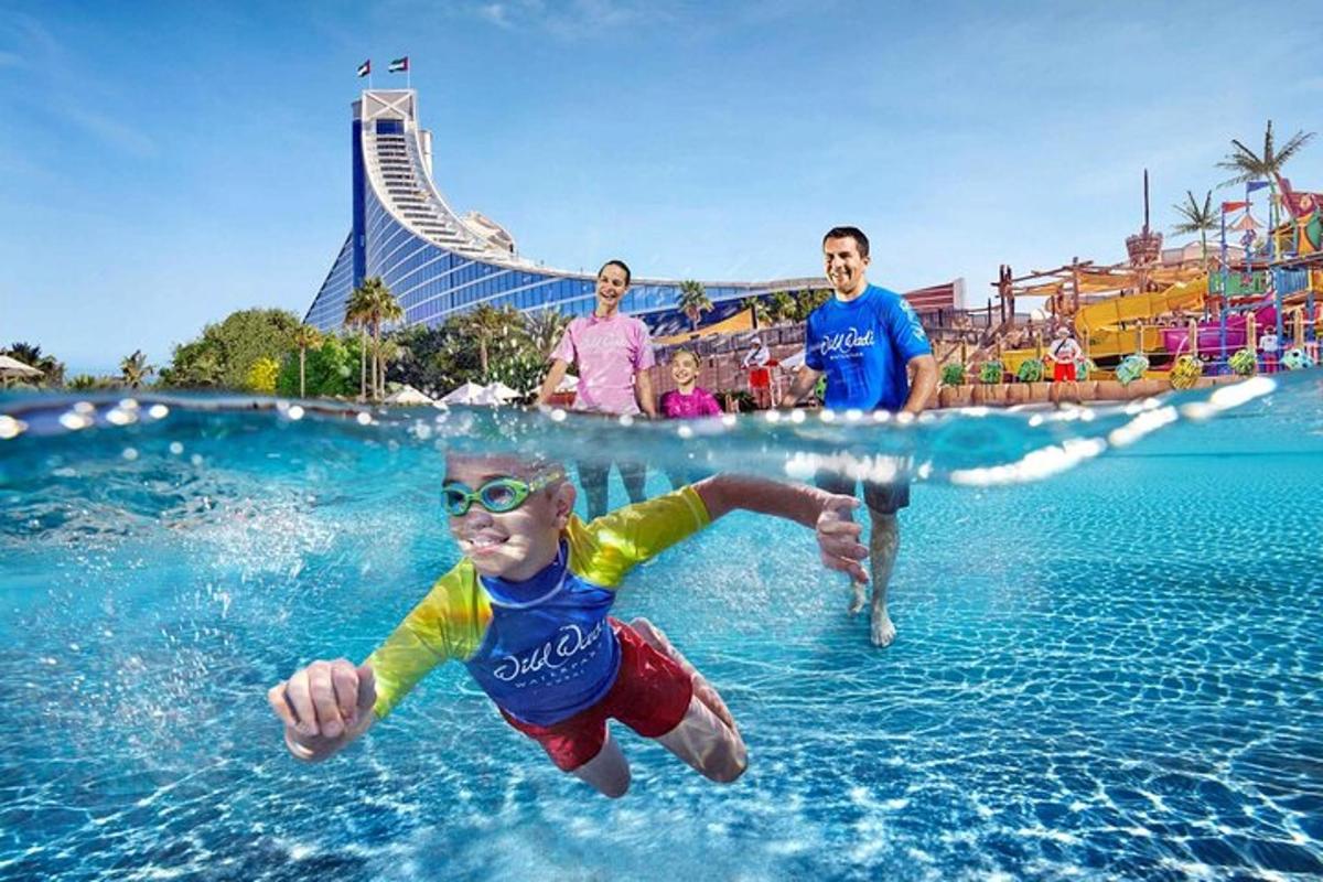 a young boy in the water at a water park