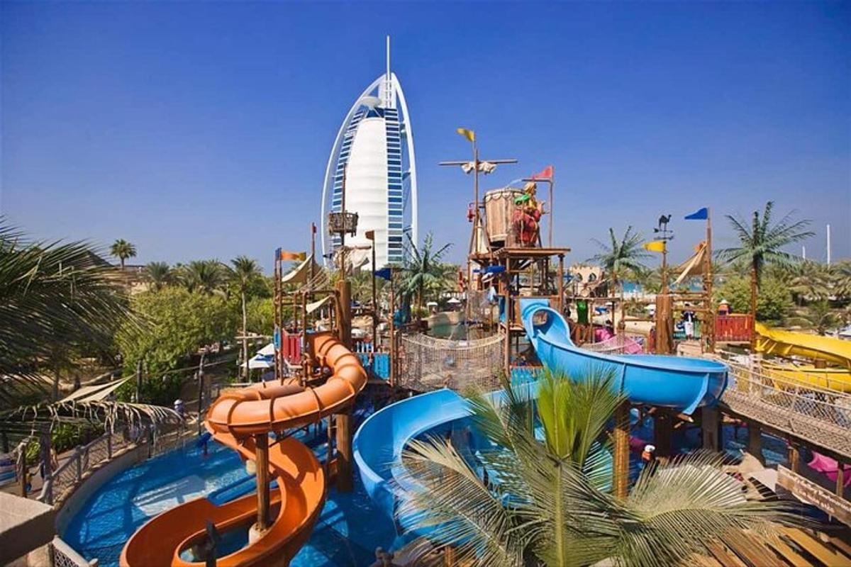 a water park with a water slide and a roller coaster