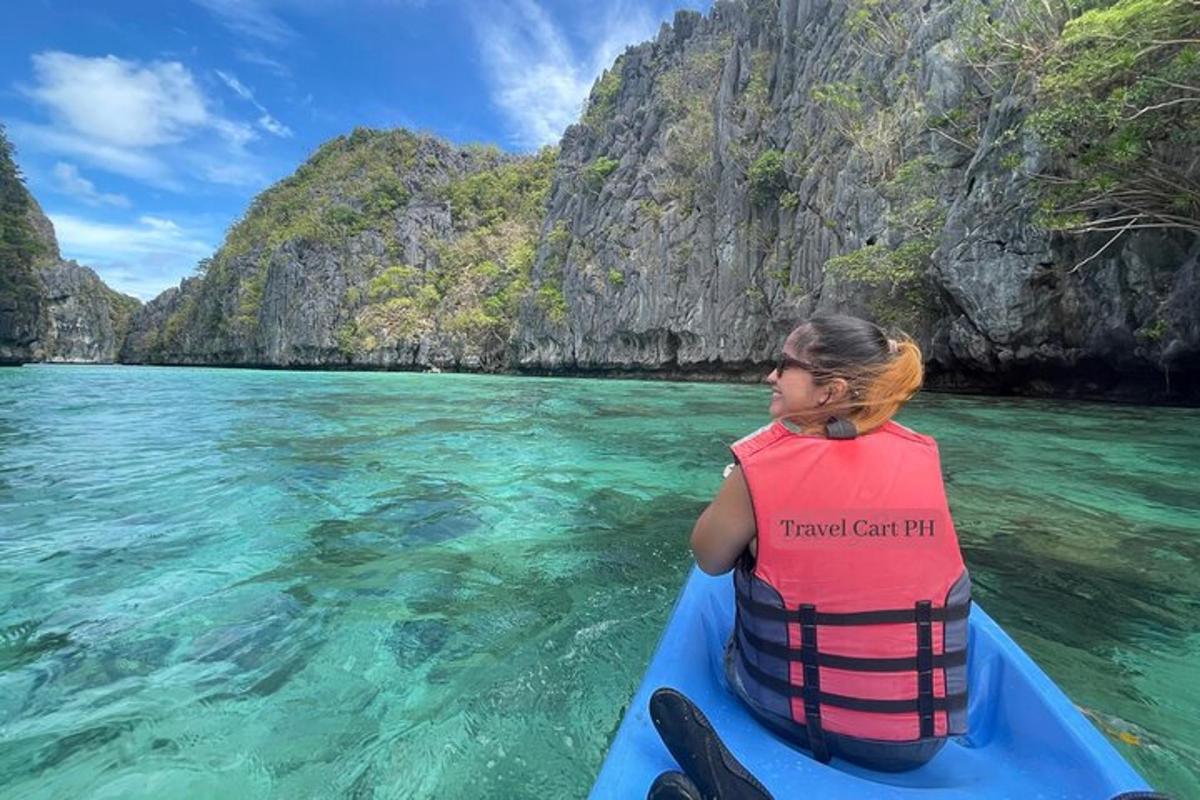 a woman is sitting in a boat in the water