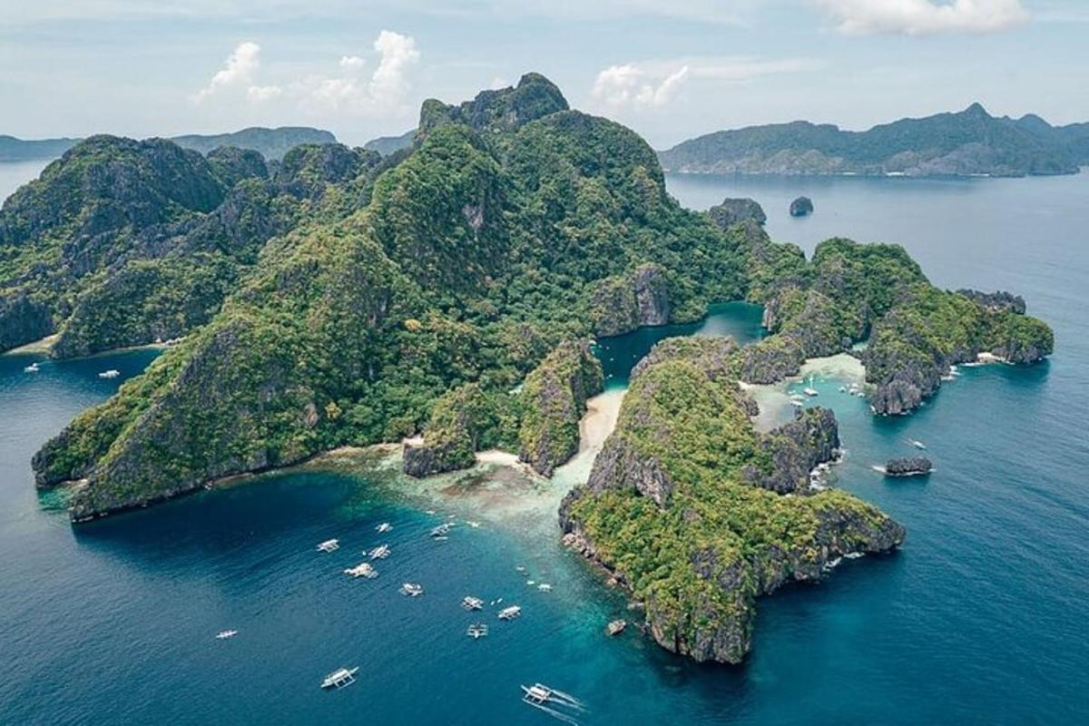 an island in the ocean with boats in the water