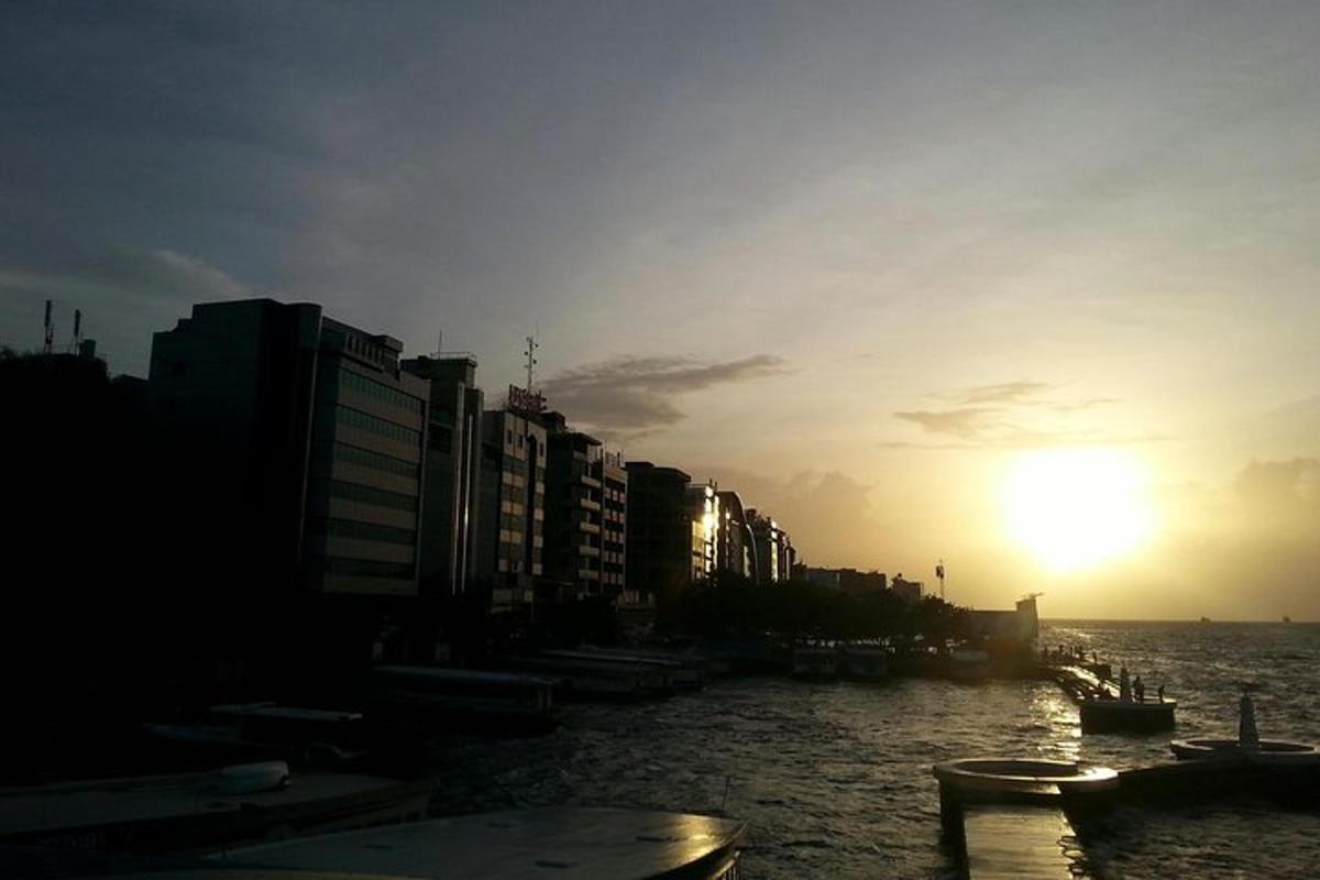 a view of a river with buildings and the sunset