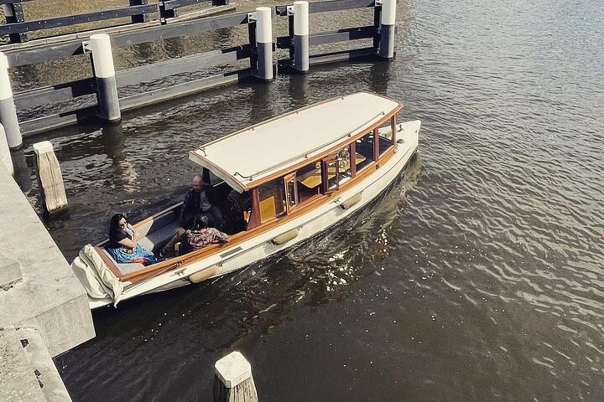 a boat in the water next to a bridge