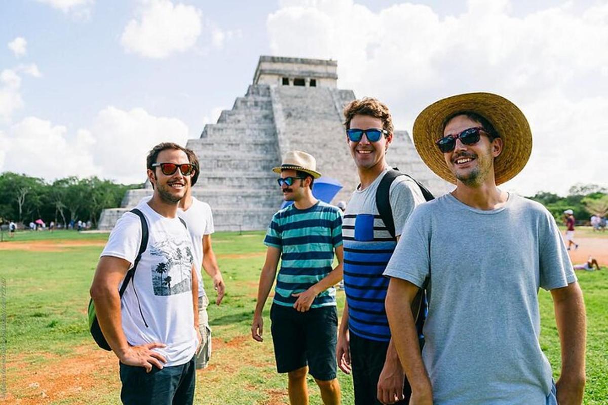 a group of men standing in front of a pyramid