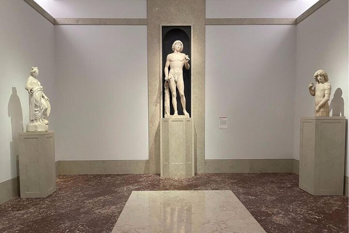 a museum with statues on display in a room