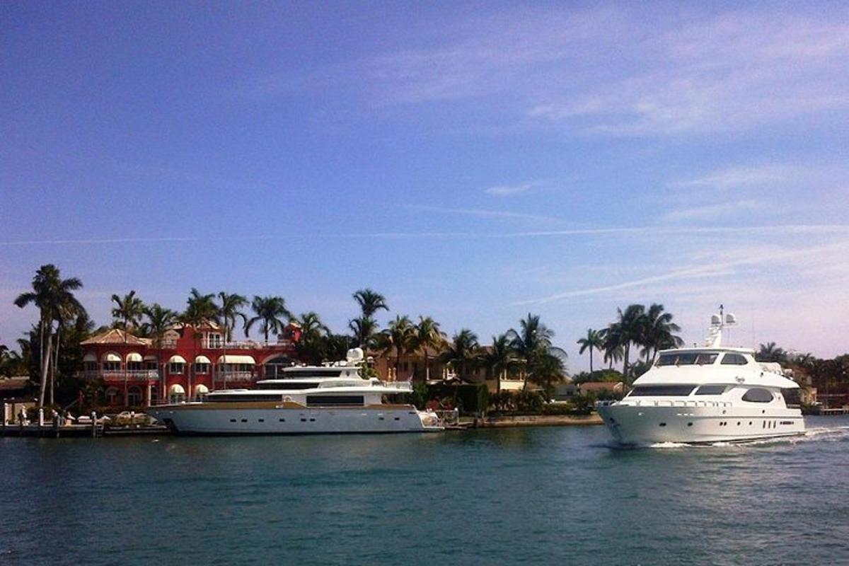 two boats docked in the water in front of a house