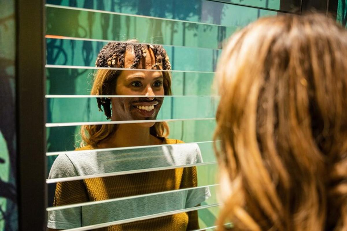 a woman standing in front of a mirror