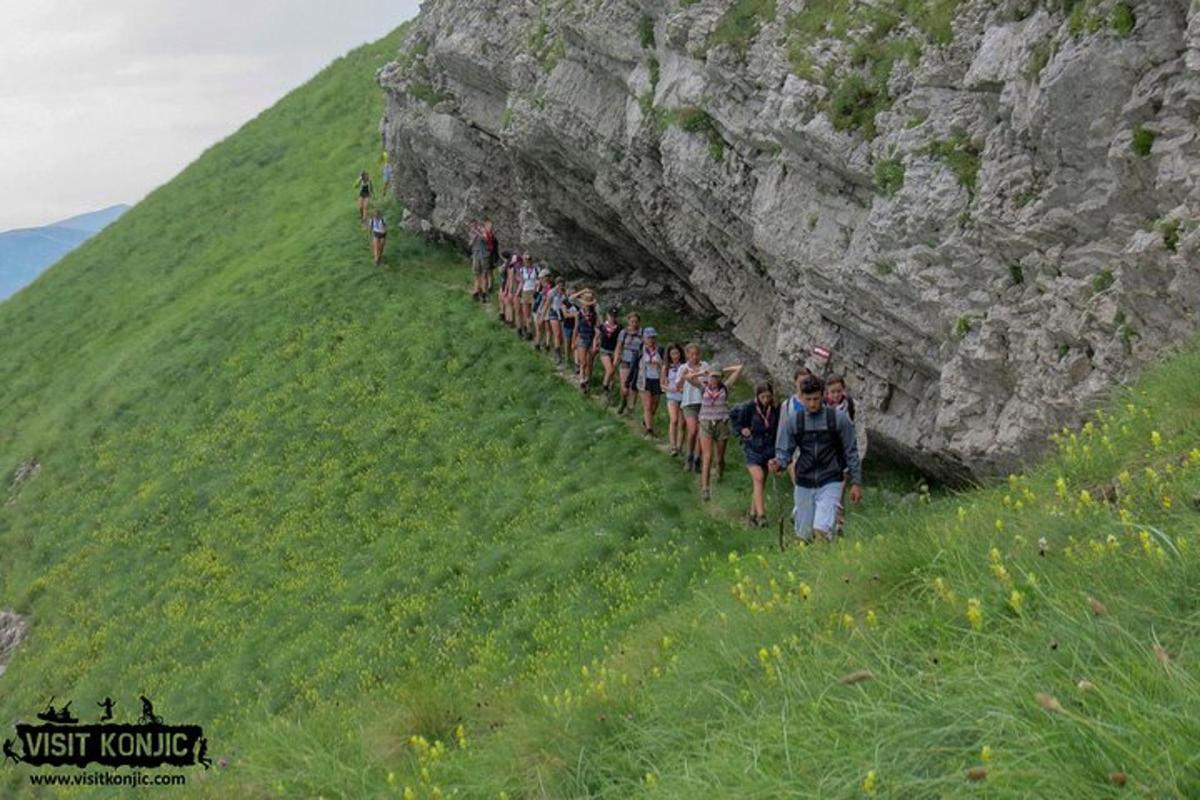 a group of people walking up a hill