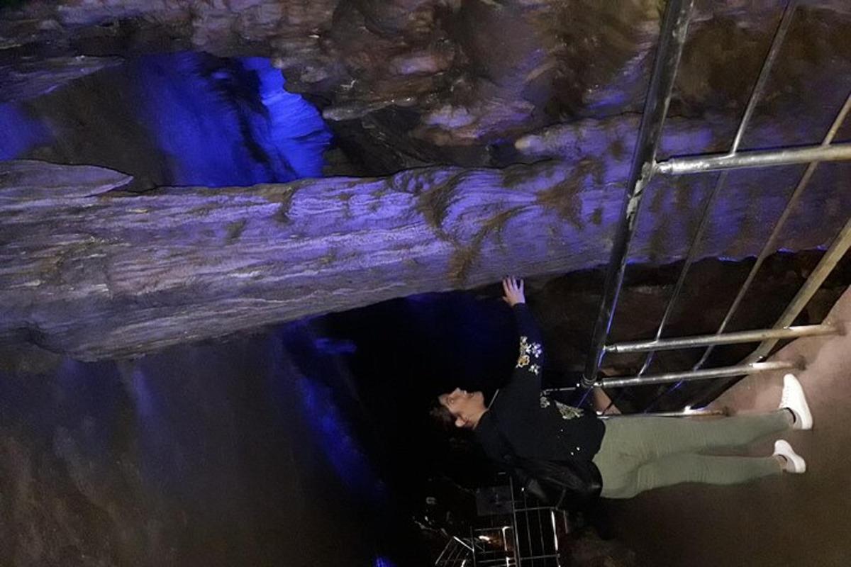 a man standing on a bunk bed in a cave